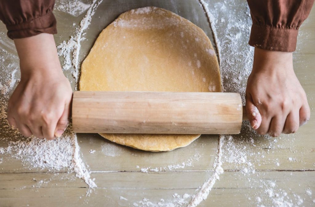 Rolling pin rolling out dough - kids baking in the kitchen