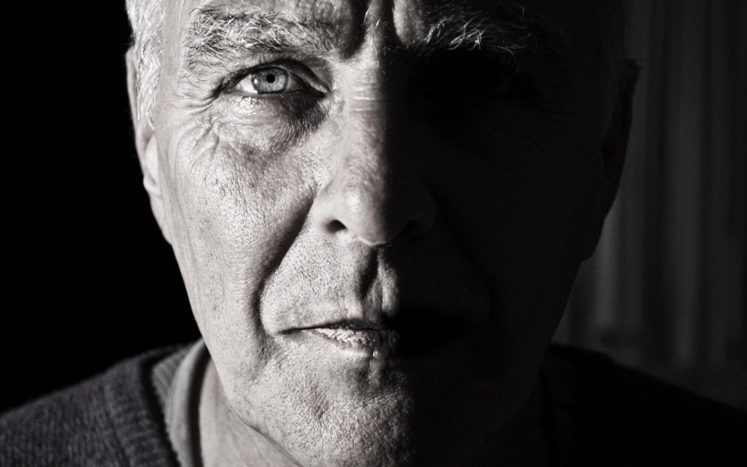 Depression in men - image of black and white older man look into camera