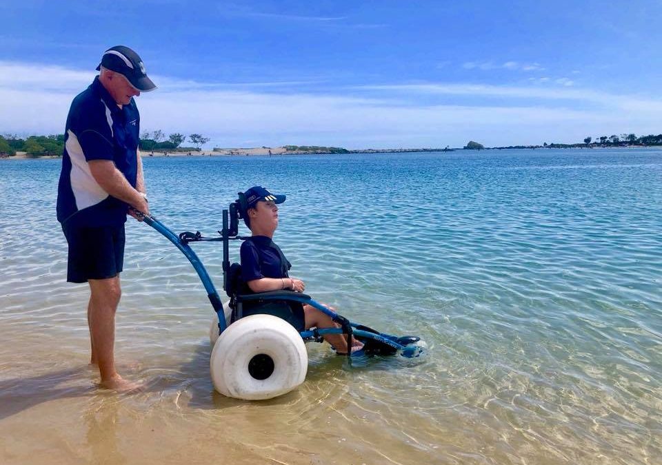Person in beach wheelchair enjoying the sea